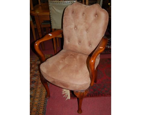 A pair of contemporary walnut framed and tan suede button upholstered elbow chairs in the early Georgian taste, raised on aca