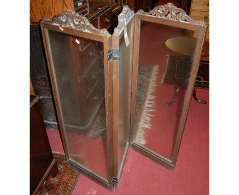 An early 20th century French oak framed and clear glass inset three division low screen, having pierced and stylised floral u