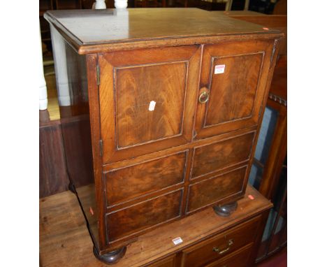 A Victorian mahogany commode in the form of a side cupboard, having hinged lid and twin upper doors, width 58.5cm