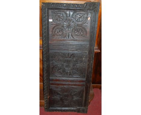 An antique relief carved oak panel, 135 x 56cm