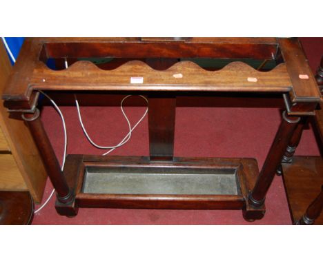 An early Victorian mahogany long stick stand, the wavy divisions raised on plain turned columns, width 84cm