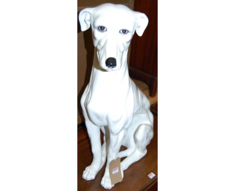A contemporary Italian large glazed ceramic figure of a seated whippet, printed and hand painted marks Made in Italy verso, h