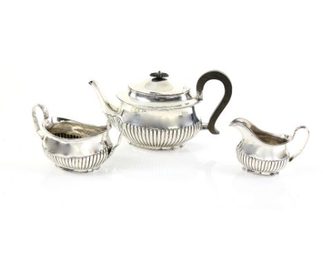 Victorian silver three piece tea service, comprising teapot, cream jug and sugar bowl, with half-gadrooned body, by William H