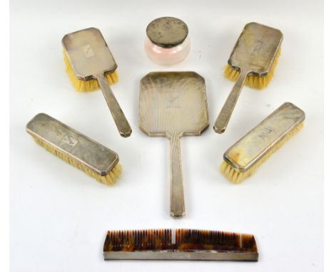 George VI silver-mounted dressing table set, comprising two long handled brushes, two further brushes, a tortoiseshell comb, 