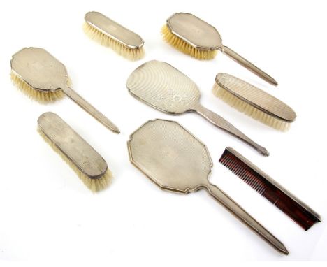 George VI silver backed part dressing table set, comprising three brushes and hand mirror, with engine turned decoration, Adi