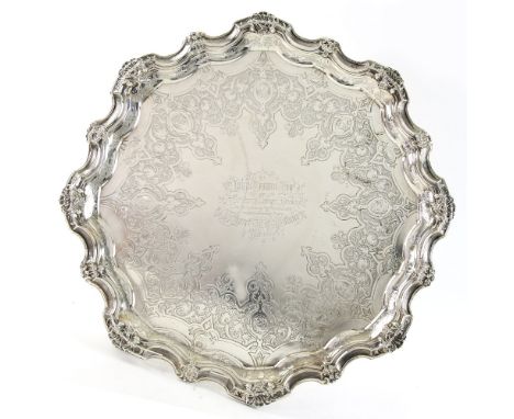 Victorian silver salver with moulded shell and engraved decoration on four scroll feet, by R &amp; S Garrard &amp; Co., Londo