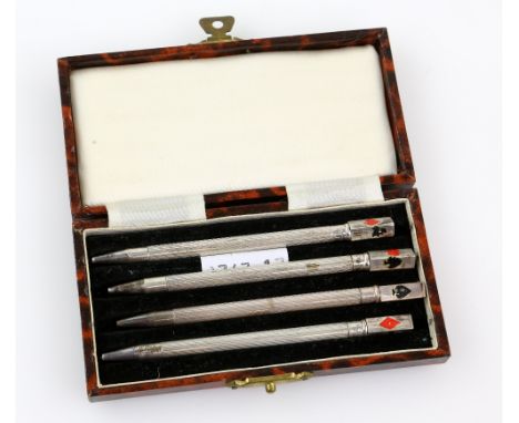 Set of four sterling silver and enamel bridge pencils, with engine turned decoration, in fitted case, each 9 cm long .   Over