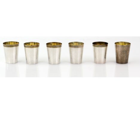 Set of six sterling silver tot cups, with planished finish and gilt interiors, 5.5 cm high, 304 gr. (6).   