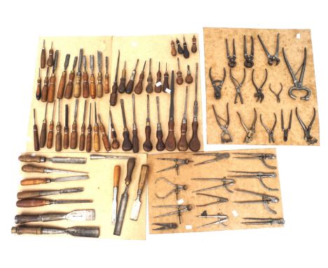 An assortment of tools. Including chisels, pliers, screwdrivers, etc, the majority with wooden handles