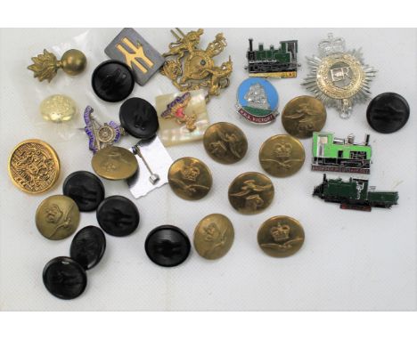 An assortment of buttons and badges. Including military and enamel examples