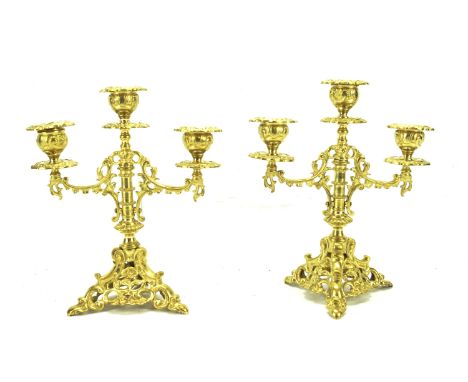 A pair of gilt candelabra. With scroll decoration, raised on tripod supports, H23cm