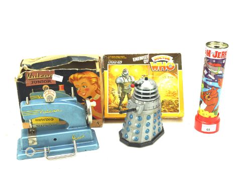 An assortment of vintage toys. Including a Tomy plastic battery-operated Dr Who Dalek, a boxed Vulcan Junior child's sewing m