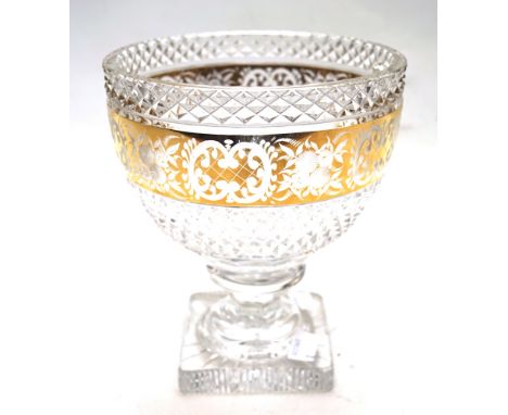 A large cut and gilt glass footed bowl. Cut with diamonds, engraved with a band of flowers, diaper pattern and C-scrolls on g