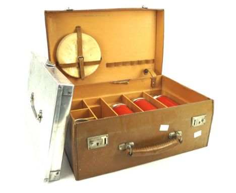 A vintage picnic hamper. The brown leather case with a fitted interior containing cocktail shakers and a cool tray, L41cm