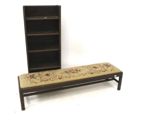 A free standing oak bookcase with beaded edges and a long bench with tapestry drop in seat. L120cm