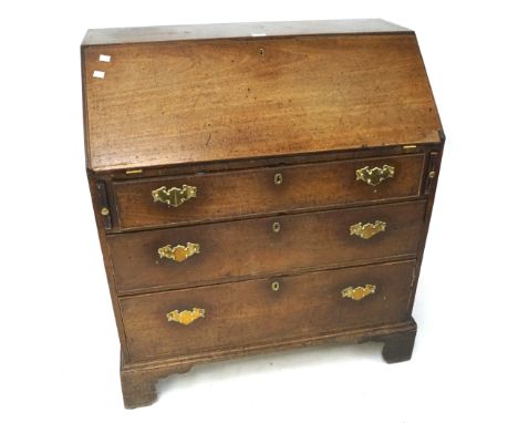 A early 20th century mahogany bureau. The upper section opening to reveal a fitted interior, the lower section with three lon