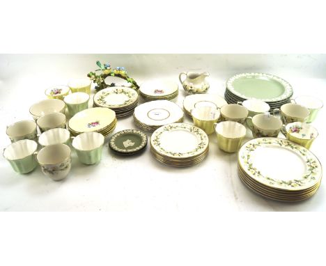 A Royal Doulton part tea service and an assortment of teacups and saucers. The tea service in the 'Clairmont' pattern, the Ro
