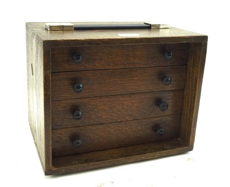 A 20th century oak engineering chest. The four drawers opening to reveal a selection of tools, carry handle to the top, L30.5