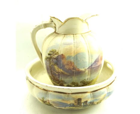 A Victorian ceramic pitcher and basin. Painted with mountain landscapes, the pitcher signed 'Leeton', H32cm