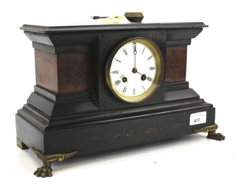A late 19th century French slate and stone set mantel clock. The enamel dial with Roman numerals denoting hours, raised upon 