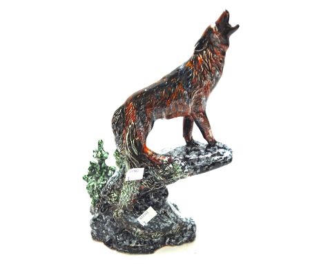 An Anita Harris flambe ceramic figure. Modelled as a wolf on rock figure, signed in silver to the base, H33cm