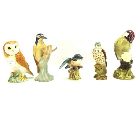 Four Beswick birds and a ceramic owl. The birds including a kingfisher, two woodpeckers and a kestrel, largest H19cm
