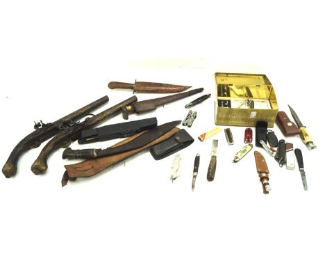 An assortment of knives and replica guns. Including pen knives, hunting knives, etc, some with bone and horn handles