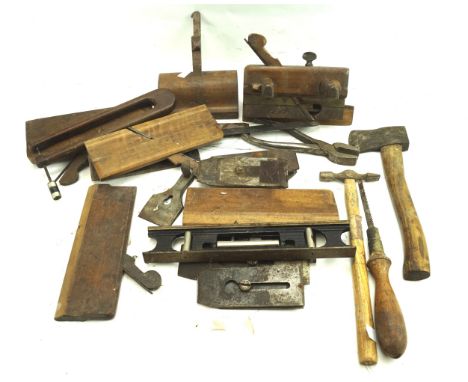 An assortment of vintage woodworking tools. Including pliers, a hammer, axe, etc, most with wooden handles, some stamped with