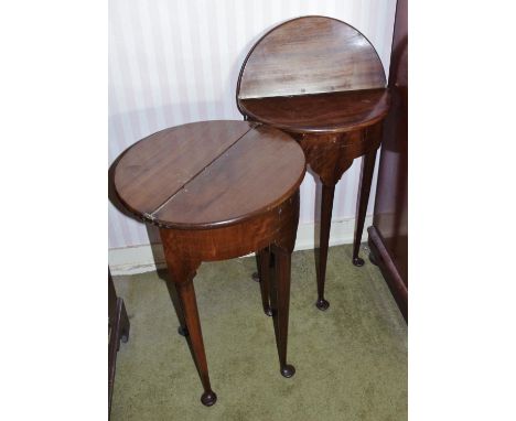 A pair of George II Revival mahogany demi-lune tea tables, of small proportions, each with folding top above a deep frieze en
