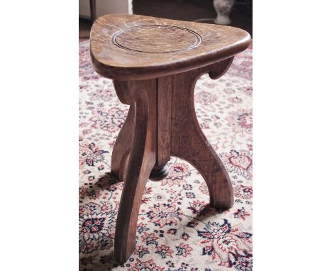 An early 20th century oak stool, rounded triangular seat, three splayed legs, turned finial, c.1910**Please note all lots mus