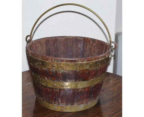A 19th century brass bound coopered oak bucket, swing handle, 25cm high, 35cm diam**Please note all lots must be collected fr