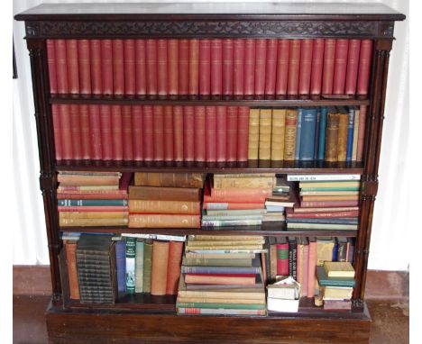 A late 19th century mahogany open bookcase, blind carved frieze three adjustable shelves, double freestanding columns, plinth