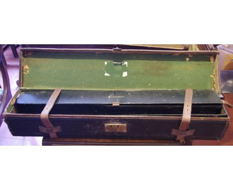 An early 20th century rectangular leather gun case, the interior with black metal compartments, 82cm long, 17cm wide**Please 