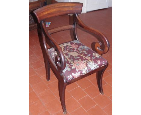 A Regency mahogany elbow chair, with curved oversailing cresting rail, downswept shepherds crook arms, drop-in seat, sabre le