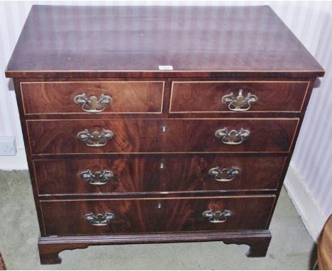 A George III mahogany chest, of small proportions, slightly over sailing top above two short and three long graduated drawers