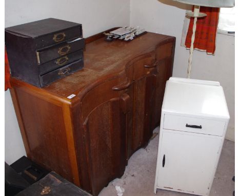 A 1930 oak sideboard;  a wrought iron standard lamp;  white painted bedside cabinet (3)**Please note all lots must be collect