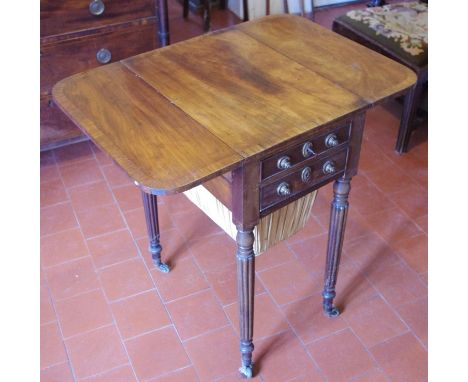 A Regency mahogany drop-leaf rounded rectangular work table, the crossbanded top above two long graduated drawers with brass 