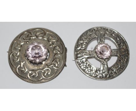 A Scottish Celtic circular cloak brooch, cast with figures and strapwork, pierced with a cross and centred with  an amethyst;