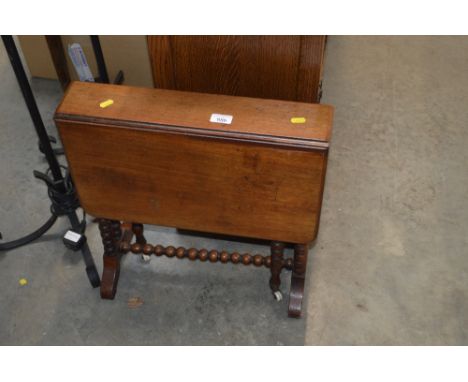A mahogany Sutherland table raised on bobbin supports 