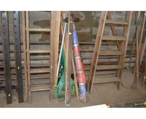 A quantity of long handled gardening tools and a bundle of bamboo canes