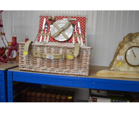A wicker picnic hamper and contents
