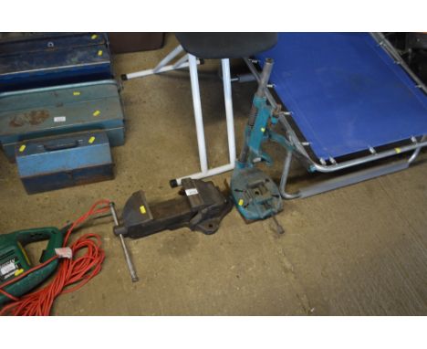 A bench vice together with a drill press 