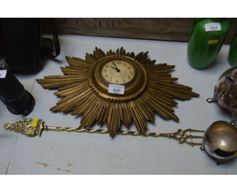 A sunburst cased wall clock;; together with a toasting fork 
