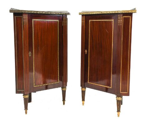 A Pair of Late 19th Century Mahogany and Gilt Metal Mounted Encoignures, with canted rectangular tops and pierced brass galle