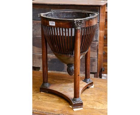 A 19th century mahogany neo classical planter the slatted pierced basket raised on the corinthian columns over a triform plin