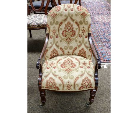 A Victorian carved rosewood and upholstered button back open armchair