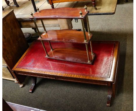 A reproduction mahogany leather inset sofa table, on carved scroll supports with a turned cross stretcher, 106cm closed by 53