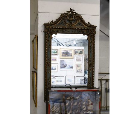 A George II style green painted and parcel gilt pier mirror with swan neck pediment and floral festoons, 78cm by 140cm; toget