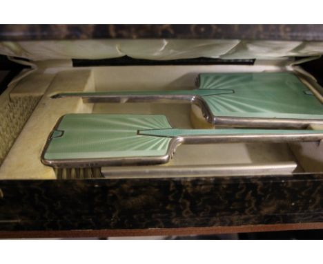 An Art Deco silver and green enamel three piece dressing table set in fitted box 