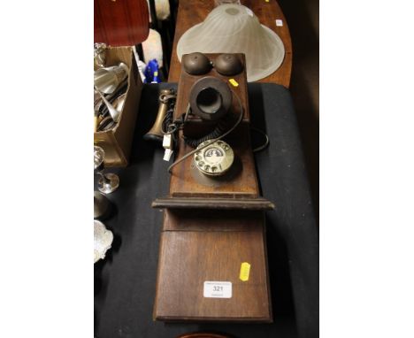 A vintage style wall hanging candlestick telephone